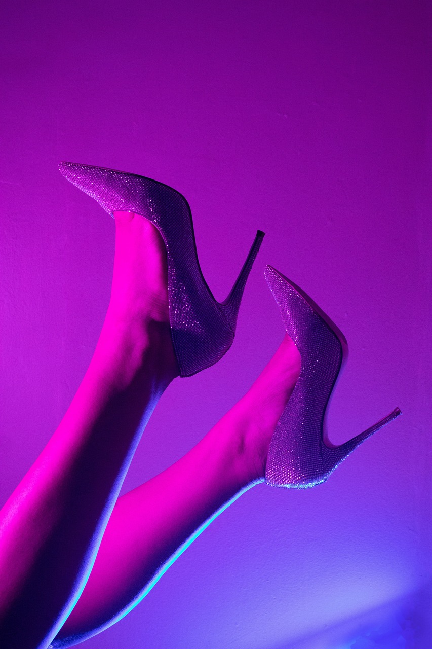 A stylish pair of legs wearing sleek high heels, exuding confidence and elegance.